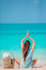 Young fashion woman in green dress on the beach