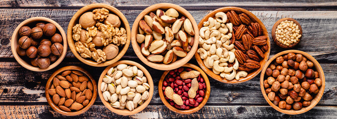 Various Nuts in wooden bowls.