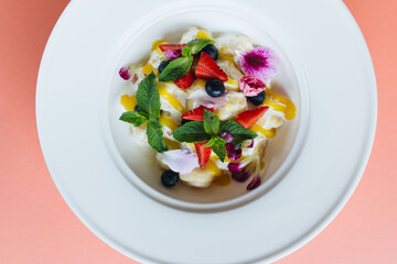 bowl of healthy salad with fresh berries and cheese