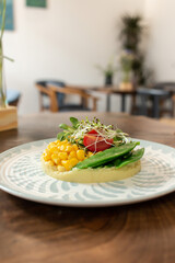 fresh salad with vegetables, basilica, tomato, corn on  yellow and green background