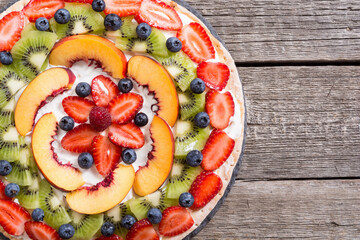 Fruit pizza with fruit and berries .