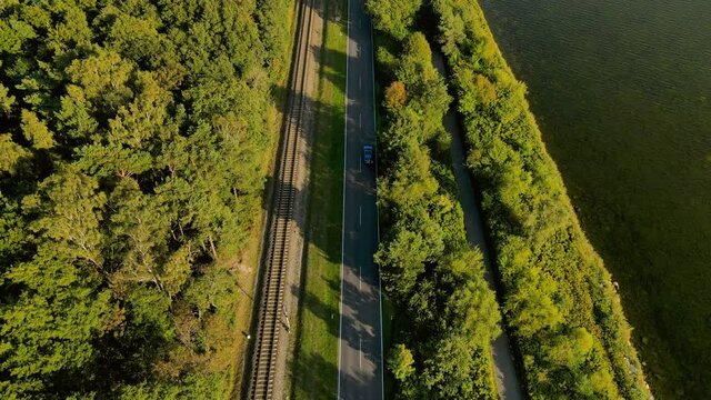 Flying over highway road and railway in Kuznica tourist spot in Hel Peninsula, Poland, baltic sea, Slow aerial flying straight forward movement