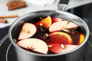 Delicious hot mulled wine on stove, closeup
