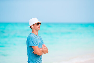 Young man on the white beach on vacation