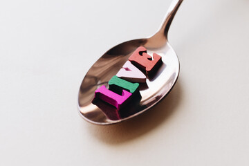 colorful wooden letters in spoon, LIVE lettering 