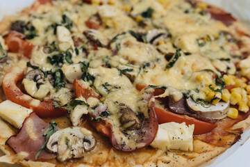 evening meal, Italian pizza, black olives, mozzarella cheese and fresh basil on a wooden background, close up