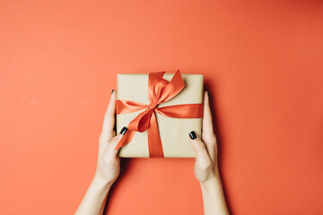 gift on red background with bow, greeting
