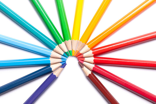 circle or semicircle of colored sharp pencils spouts in the center on a white isolated background.