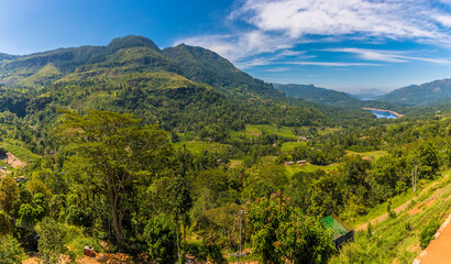 Obraz premium A view across tea country towards the distant Kothmale reservoir in Sri Lanka, Asia