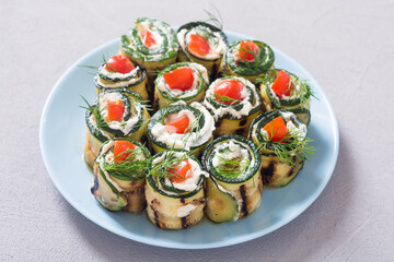 Zucchini rolls with cream cheese , tomatoes and dill