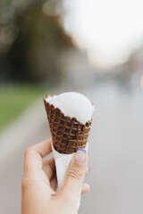 Hand holding an ice cream cones