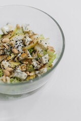 homemade healthy fresh salad with blue cheese, pears, nuts and balsamic dressing, vegetable salat