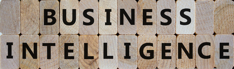 Wooden blocks form the words 'business intelligence'. Beautiful wooden background. Business concept.