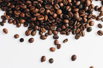Close-up view of roasted coffee beans, isolated on white 