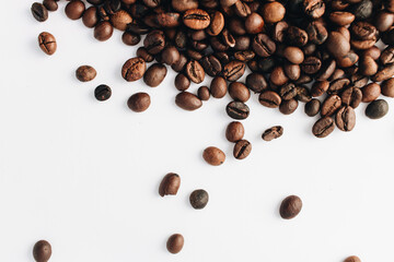 Close-up view of roasted coffee beans, isolated on white 