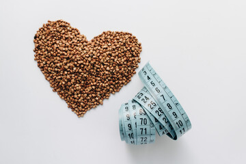 Scatterd raw buckwheat on white background