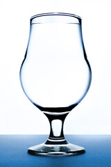 glass of water on white and blue background