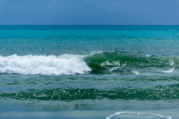 wave on the turquoise sea, amid storm clouds