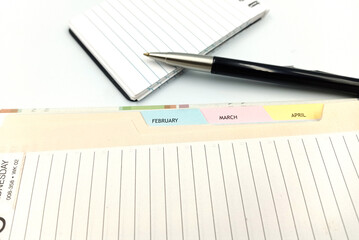 Naklejka premium Notice diary with the pen on the isolated white background