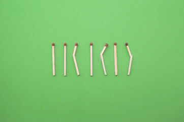Conceptual figures from matches on a bright background. Downtime and minimal art object. Not like everyone else, different from the crowd