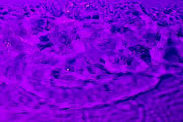 splash of water in lilac light. Abstract wallpaper