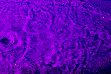 splash of water in lilac light. Abstract wallpaper