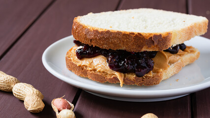 fast food, snack, peanut butter and fruit jam sandwich on a wooden table