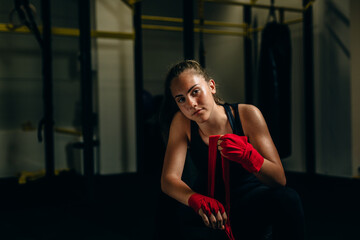 woman wrapping boxing bandages indoor