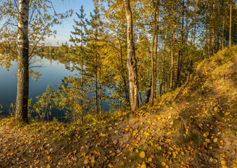 Fototapeta premium Beautiful autumn evening on the bank of the quarry.