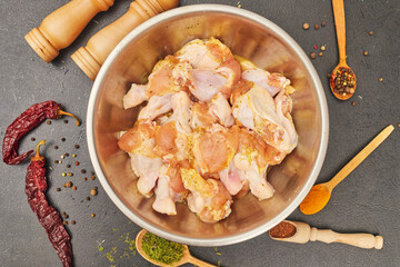 marinated chicken wings in a metal bowl on the table