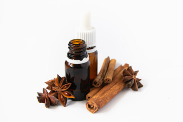 natural cosmetics concept, composition of glass bottles with oil, anise and cinnamon sticks on a...