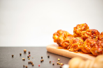Buffalo chicken wings on wooden board with celery copies space