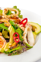 Seafood salad with avocado and greens on white
