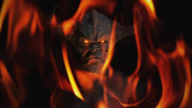 Animation of the appearance of a devil from the darkness or fire. Horror or religion scene.