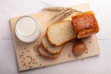 white bread with milk and an egg on a cutting board top view
