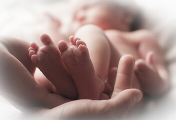 Obraz na płótnie Canvas Small feet of a newborn close up