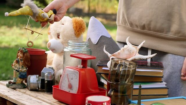 Man buying old stuff at garage sale. Selling items in the yard. 