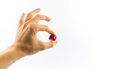Precious red stone in judging hand on white isolated background banner photo