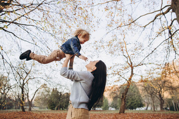 Mother with her little son in autumn park