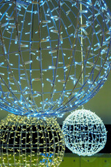 Luminous decorations in mall, sphere from garland hanging in shopping center. Selective focus, Christmas ornaments