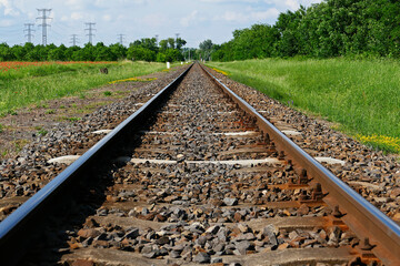Obraz premium Railway tracks in straight line in the countryside in Eastern Hungary