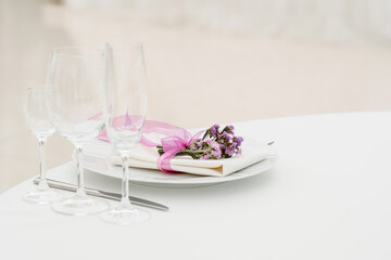 Close up of plate, fork and knife decorated with flowers on party wedding.