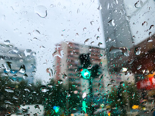 Traffic view from car windscreen in rain. Driving in rain. Selective focus.