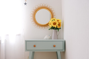 Scandinavian Bedroom Interior with Painted Mint Table, Sunflowers and Stylish Wooden Chair. Concept of modern home interior.