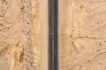 Desert road, Aerial image of a new two lane road surrounded by dry desert landscape