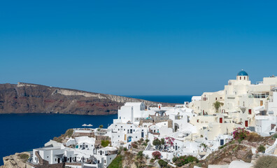 Fototapeta na wymiar Panoramic view of Oia town in Santorini island with old whitewashed houses and traditional windmill, Greece Greek landscape on a sunny day