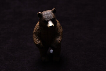 Toy brown bear on a dark background.