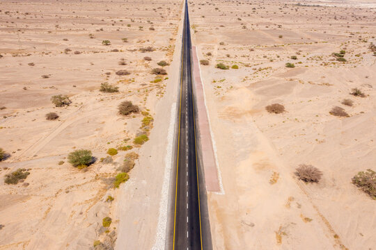 Desert Road, Aerial Image Of A New Two Lane Road Surrounded By Dry Desert Landscape