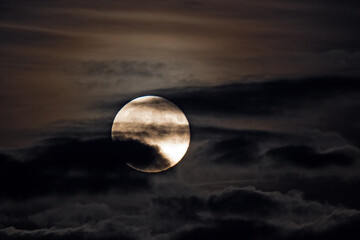 Full Moon shining through clouds in the night sky, Heidelberg, Germany