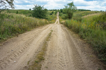 A long road in an arable field. Farmland. A beautiful field road